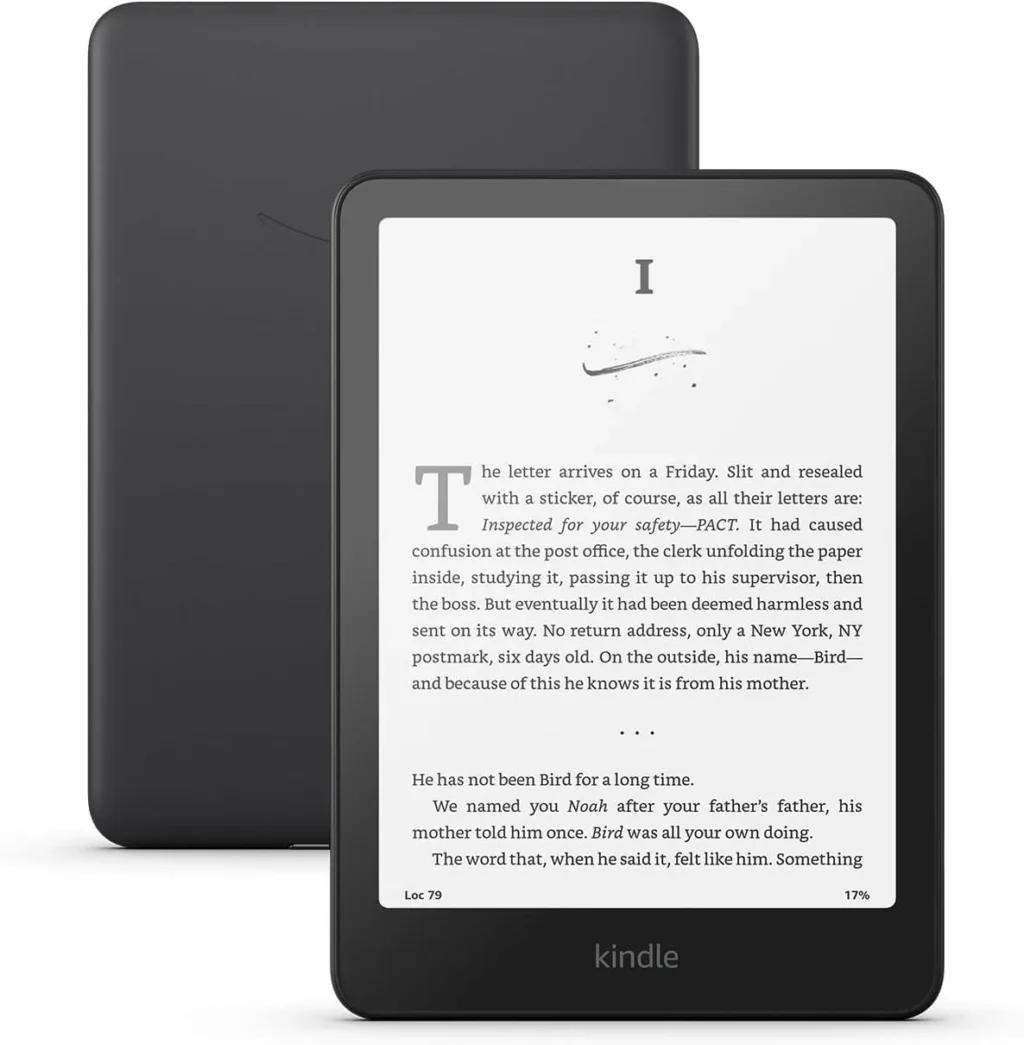 Black Kindle e-reader displaying a page of a novel, shown in front of its matte black back cover.