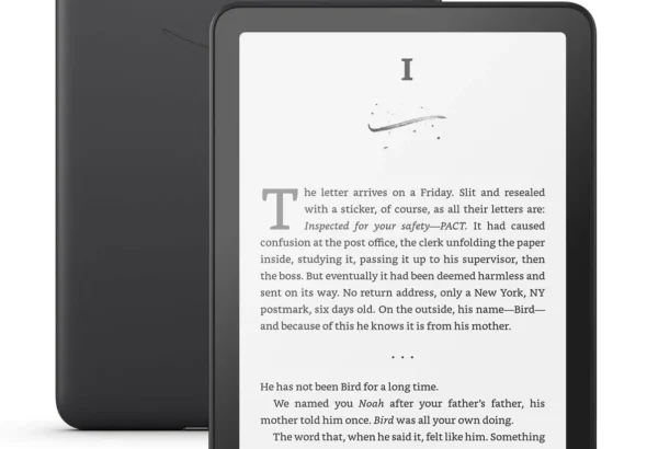 Black Kindle e-reader displaying a page of a novel, shown in front of its matte black back cover.