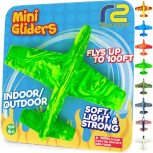 Bright green foam mini glider airplane toy on packaging labeled “Mini Gliders,” suitable for indoor and outdoor play, flies up to 100 ft, ages 4 and up