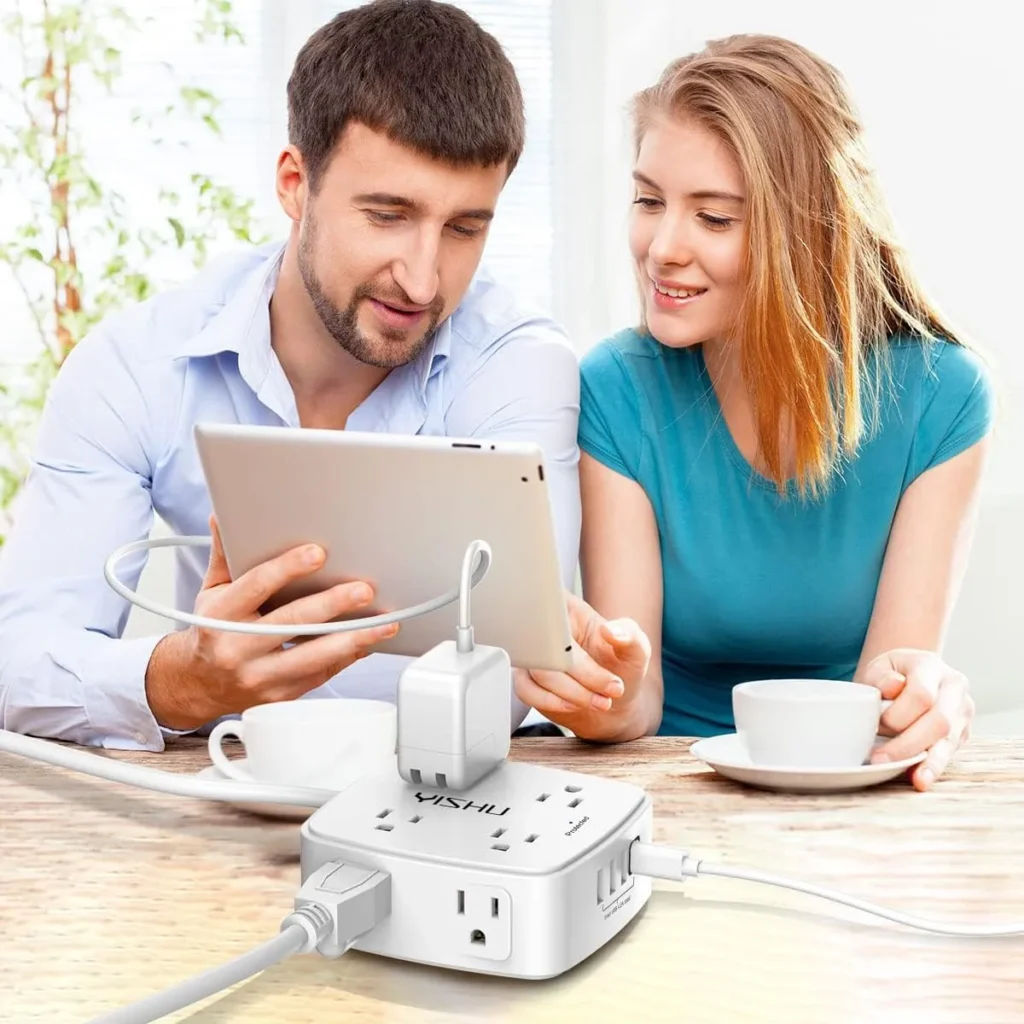Couple using tablet at table with white 6 ft surge protector power strip featuring 8 outlets and 4 USB ports