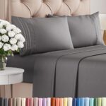 Dark grey queen-size bed sheet set with pillowcases on a tufted beige headboard, styled with a bedside table and white flowers; color options displayed below.