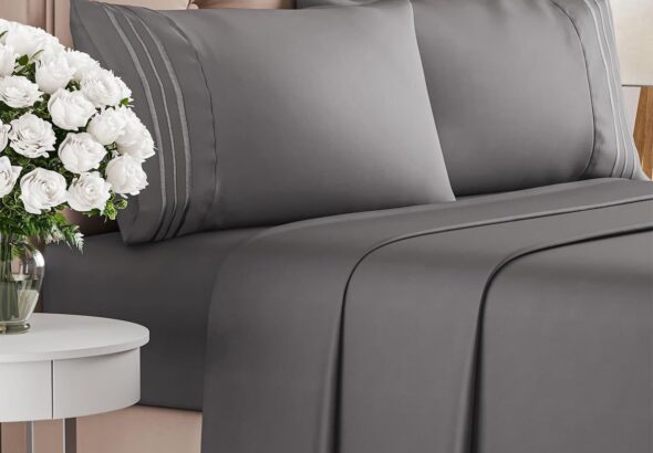 Dark grey queen-size bed sheet set with pillowcases on a tufted beige headboard, styled with a bedside table and white flowers; color options displayed below.