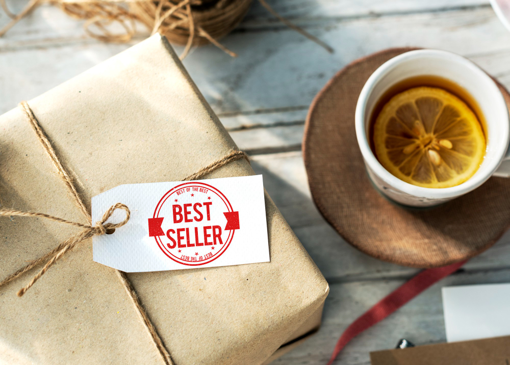 Gift box with best seller tag next to a cup of tea with lemon on a rustic table