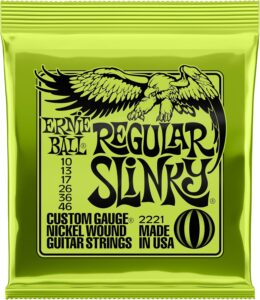 A pack of Ernie Ball Regular Slinky electric guitar strings in a bright neon green foil wrapper featuring a black eagle graphic.