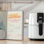 Modern white air fryer displayed on a kitchen counter beside an open recipe book.