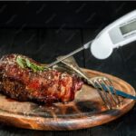 Best meat thermometers comparison showing ThermoPro, Lavatools, MEATER Plus, and Thermapen ONE instant read and digital meat thermometers