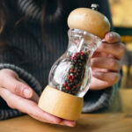 Best pepper grinders comparison showing manual and electric pepper mills from Peugeot, OXO, and Cole & Mason