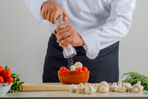 Best salt and pepper shakers comparison showing ceramic, glass, and stainless steel shaker sets from Le Creuset, Menu, and OXO