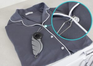 Button hook tool threading a button through a shirt buttonhole