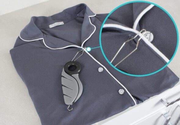 Button hook tool threading a button through a shirt buttonhole