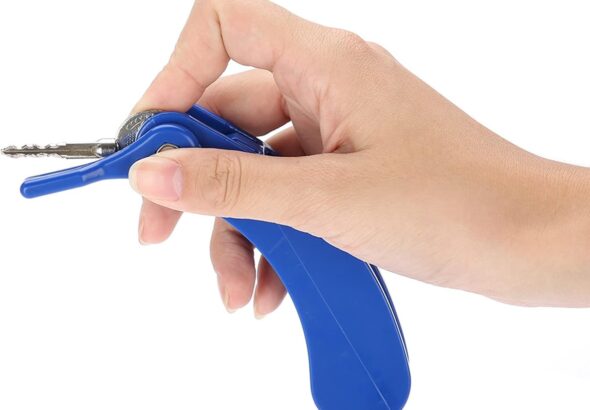 Key turner clipped onto a house key on a wooden table