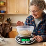 Blind woman using a talking kitchen scale with large tactile buttons while baking